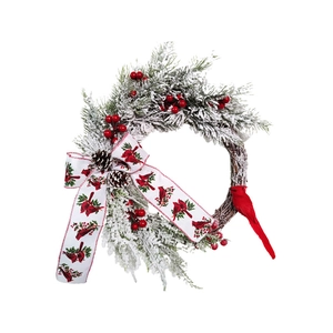 Christmas wreath with flocked pine needles, red berries, cones and a cardinal bird