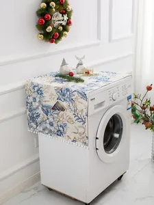 Detail of linen dust cover featuring floral patterns, side pockets and white pom-pom trim