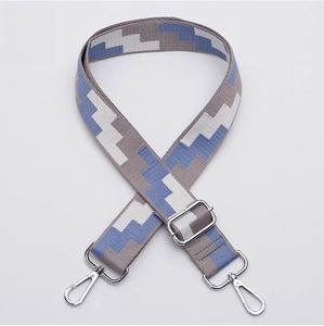 Close-up of adjustable blue and grey geometric jacquard strap with silver spring hooks