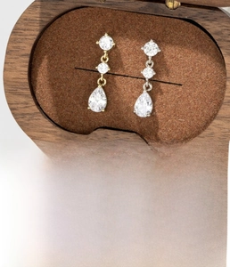 Detail view of coffee gold teardrop zircon earrings with titanium steel screw backs
