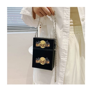 Detail of Halloween chain bag with yellow moon, castle silhouette and silver strap