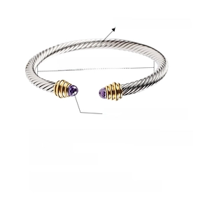 Detail view of silver cable twisted stainless steel bracelet with purple crystal accents