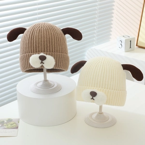 Detailed knit texture of cute puppy winter hats for infants on a minimalist display