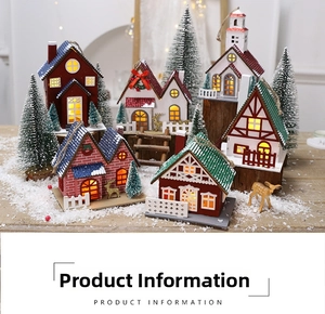 Close-up of lighted wooden Christmas house ornaments with faux snow and mini deer