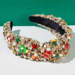 Detail of tweed headband decorated with festive pearls, rhinestones and Christmas charms