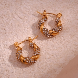 Detailed macro view of 18K gold plated twisted hoop earrings with pave set zircons