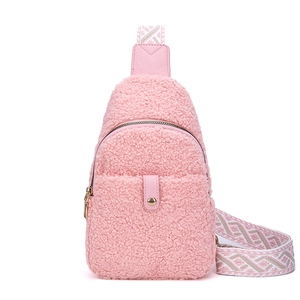 Pink fleece crossbody bag with geometric woven strap and snap button front pocket