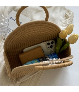 Detail showing spacious interior of a woven straw bag with summer beach essentials