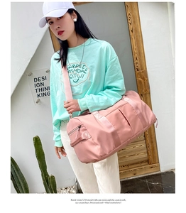 Pink waterproof nylon duffel bag with adjustable shoulder strap for travel and fitness