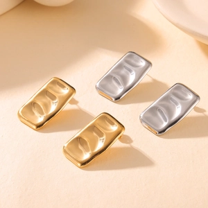Golden and silver geometric rectangle earrings with layered textured metal design