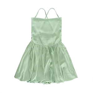 Detailed view of backless cross strap design and pleated light green silk dress