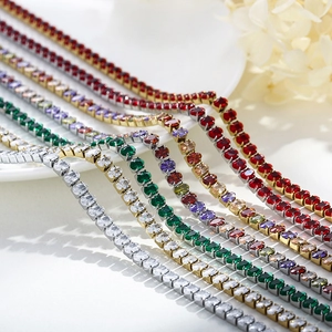 Detail of colorful tennis necklaces featuring emerald and ruby stones in claw settings