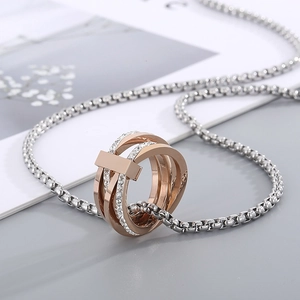 Macro view of multi-layer rose gold and silver pendant with T-bar and crystals