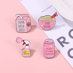Flat lay of four funny pink enamel pins featuring strawberry milk and ramen bowl designs