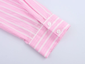 Detail of pink and white striped shirt cuff with dual buttons and neat stitching