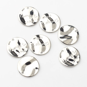 Detailed view of silver-plated round charms featuring engraved 'things to come' text