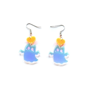 Macro detail of acrylic iridescent ghost earrings with a yellow heart stud design