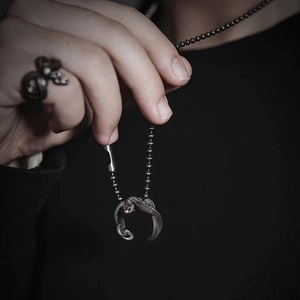 Vintage punk snake jewelry set featuring a silver wrap ring and pendant necklace on model