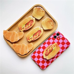 Creative 3D food-shaped phone grip featuring realistic hot dog and croissant designs