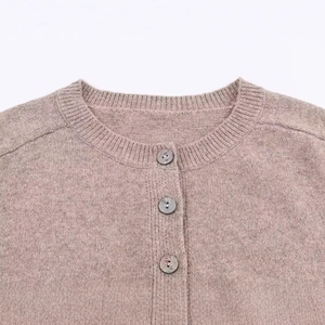 Women's pink knit cardigan with marble buttons and ribbed crew neck design