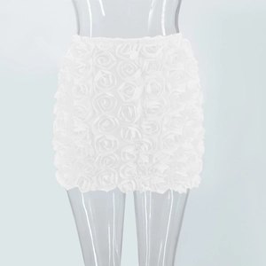 Detailed view of the white mini skirt featuring intricate 3D rose flower applique design