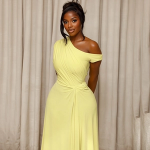 Detailed view of the yellow one-shoulder maxi dress with ruched waist and silky fabric