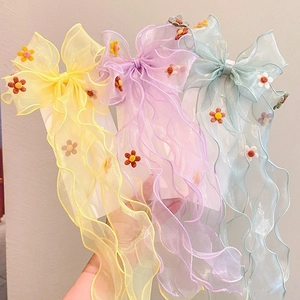 Three tulle hair bows with embroidered flowers and long streamers in yellow purple and blue