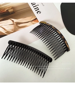 Detail of bear hair comb with leopard print texture and gold Baby logo plaque