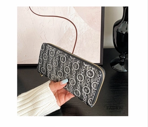 Close-up of long women's wallet with retro chain pattern and gold zipper detail