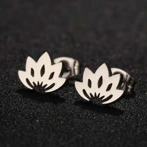 Macro shot of silver stainless steel lotus flower stud earrings on black surface