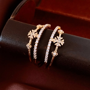 Close-up of gold-plated double-layer floral earrings with cubic zirconia inlay detail