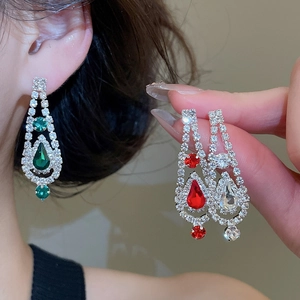 Detailed view of rhinestone water drop tassel earrings in green, red, and white crystals