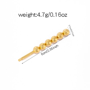 Detail of gold hair clip with five textured metal beads including weight and size specs