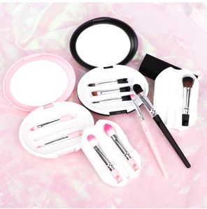 Close-up of a 5-piece portable makeup brush set with a mirror storage case and stand