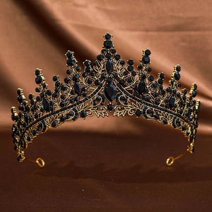 Detail of vintage gold crown featuring luxury black rhinestones on brown silk