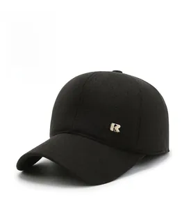 Close-up of winter baseball cap material with metal R logo and warm fleece lining
