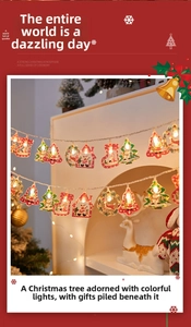 Detail of Christmas LED string lights with Santa and reindeer hanging on white fireplace