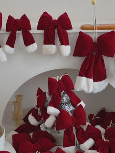 Detail of red velvet Christmas bow with white faux fur trim for holiday tree decorations
