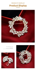 Detail of elegant brooch with white pearls and sparkling cubic zirconia on red velvet