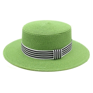 Flat top straw sun hat in grass green with black and white striped ribbon for beach