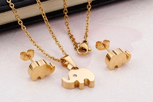 Makroaufnahme des goldenen Elefanten Schmucksets mit Kristallbesatz auf Pink