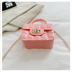 Detail of pink quilted jelly bag with golden chain strap and metallic twist-lock closure