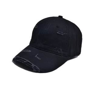 Distressed black cotton baseball cap with vintage ripped details for street fashion wear