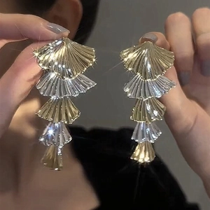 Detailed view of long tiered fan-shaped earrings with gold and silver dual-tone finish