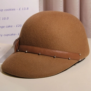 Detail of brown wool felt equestrian hat with leather strap and rhinestone accents