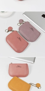 Detail of colorful PU leather coin purses with zipper closure and round tag keychains