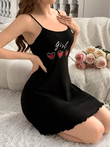 Detail of black camisole dress with white girl text and heart print on soft knit fabric