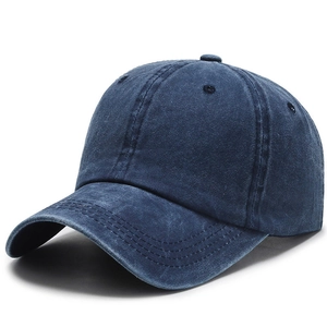 Close-up of washed navy blue cotton baseball cap with vintage denim texture and seams