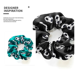 Detail showing smooth satin soccer print scrunchies in green and black colors