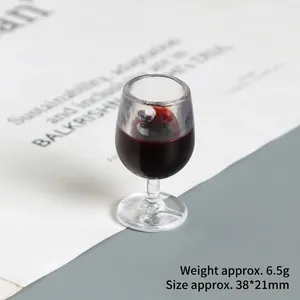 Macro detail of miniature 38x21mm wine glass resin charm with simulated red liquid